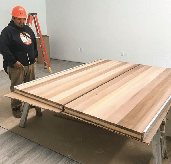 Ashley Joseph carver commences his project for the Tszil Learning Centre photo courtesy Graham Murphy Construction
